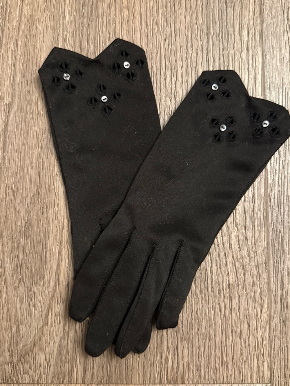 Vintage Black gloves with tiny silver buttons and eylet cut out.